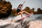 Beautiful girl skillfully jumping over the wave on surf style wakeboard