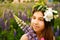 Beautiful girl smiling in a pink dress in lupins field.