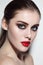 Beautiful girl with smoky eye makeup and red lips