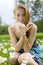 Beautiful girl with snowdrop bouquet in forest