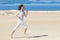 Beautiful girl in sportswear running in desert