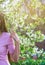 Beautiful girl with spring cherry flowers, sunshine backlit.