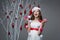 Beautiful girl standing near tree with christmas decorations