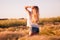 Beautiful girl at sunrise in a wheat field.