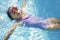 Beautiful girl swimming on blue pool