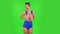 Beautiful girl in a swimsuit coquettishly is smiling. Green screen