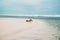 Beautiful girl in a swimsuit lies on the beach with white sand. model sunbathing on vacation near the ocean