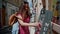 Beautiful girl tries small souvenir music box in small street gift shop. Portrait