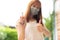 Beautiful girl using disinfectant alcohol spray. A girl wearing a surgical mask. Ways to prevent spreading.Ways to prevent the spr