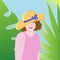 Beautiful girl on vacation in the tropics. In a big straw hat, on a background of palm leaves. The concept of travel