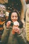 A beautiful girl in a warm jacket eats trdelnik or Trdlo with cream in her hands, in the winter in the Czech Republic, Prague at t