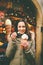 A beautiful girl in a warm jacket eats trdelnik or Trdlo with cream in her hands, in the winter in the Czech Republic, Prague at t