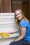 Beautiful girl washes refrigerator