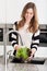 Beautiful girl washing lettuce