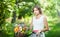 Beautiful girl wearing a nice white dress having fun in park with bicycle. Healthy outdoor lifestyle concept. Vintage scenery