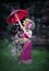 Beautiful girl wearing Thai dress and umbrella flower flow background old temple local country thailand
