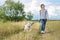 Beautiful girl with white dog, teenager walking with husky pet