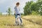 Beautiful girl with white dog, teenager walking with husky pet