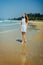 Beautiful Girl in White Dress Enjoy and Relax on The Beach. Travel and Vacation