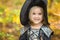 Beautiful girl witch. little girl in which costume celebrate Halloween outdoor and have a fun. Kids trick or treating