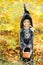 Beautiful girl witch. little girl in which costume celebrate Halloween outdoor and have a fun. Kids trick or treating