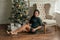 Beautiful girl woman in decorated house, happy new year. New Year Christmas. Girl portrait. Christmas tree. Brunette