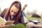 Beautiful girl writing in a book