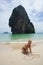 Beautiful girl writing heart on the sand in Thailand