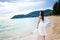 Beautiful girl young woman asia standing in water on sandy on the beach at sunset,enjoy summer vacation on the beach