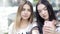 Beautiful girls take selfies on smartphone