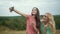 Beautiful Girls Taking Photos On Phone In Nature.