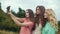 Beautiful Girls Taking Photos On Phone In Nature.