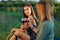 Beautiful girls tasting wine in a field near vineyard field. Celebrating successful harvest season. Couple having a romantic date