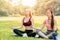Beautiful girls teen friend do yoga for healthy in green park holiday sitting relax hand lotus eyes closed concentration posture