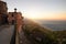 A beautiful glaring sunrise with a red building and distant coastline