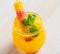 Beautiful glass of orange coctail decorated with colorful iced
