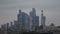 Beautiful glass skyscrapers on background cloudy sky in evening. Action. Urban landscape with glowing business high