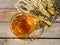 Beautiful glass teacup with Greek mountain herbal Vounou tea tea and dried mountain grass Sideritis syriaca on a wooden table in