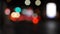 Beautiful glittering bokeh in dark blurry background at night. The round colorful bokeh shine from car lights in traffic