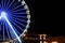 Beautiful glowing Ferris wheel in city at night. Space for text