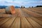 Beautiful golden hour hay bales sunset landscape with wooden planks floor