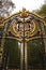 Beautiful golden-hued gate standing before a majestic brick wall in London, United Kingdom