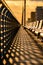 Beautiful golden light during magic hour casting symmetrical shadows on a wooden boardwalk - Long Beach NY