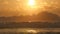 Beautiful golden ocean waves on sunset. Orange sunrise reflected at the sea water. Strong tide with waves splashes on a