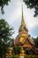 Beautiful golden pagoda with decorative Thai style fine art at public Buddhist Wat Phu Phlan Sung, Nachaluay, Ubon Ratchathani, Th