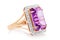 Beautiful golden ring with large amethyst and cubic zirconias isolated