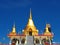Beautiful golden stupas soar into blue sky