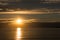 Beautiful golden sunset at calm adriatic sea, last beam of the sun makes a golden path on waveless water surface. Enlighted with o