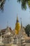 Beautiful golden and white pagodas in Sri Lankan style at Wat Suan Dok (flower garden temple) with blue sky background. Wat Suan D