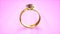 beautiful goldish diamond wedding ring on gentle pink - object 3D rendering